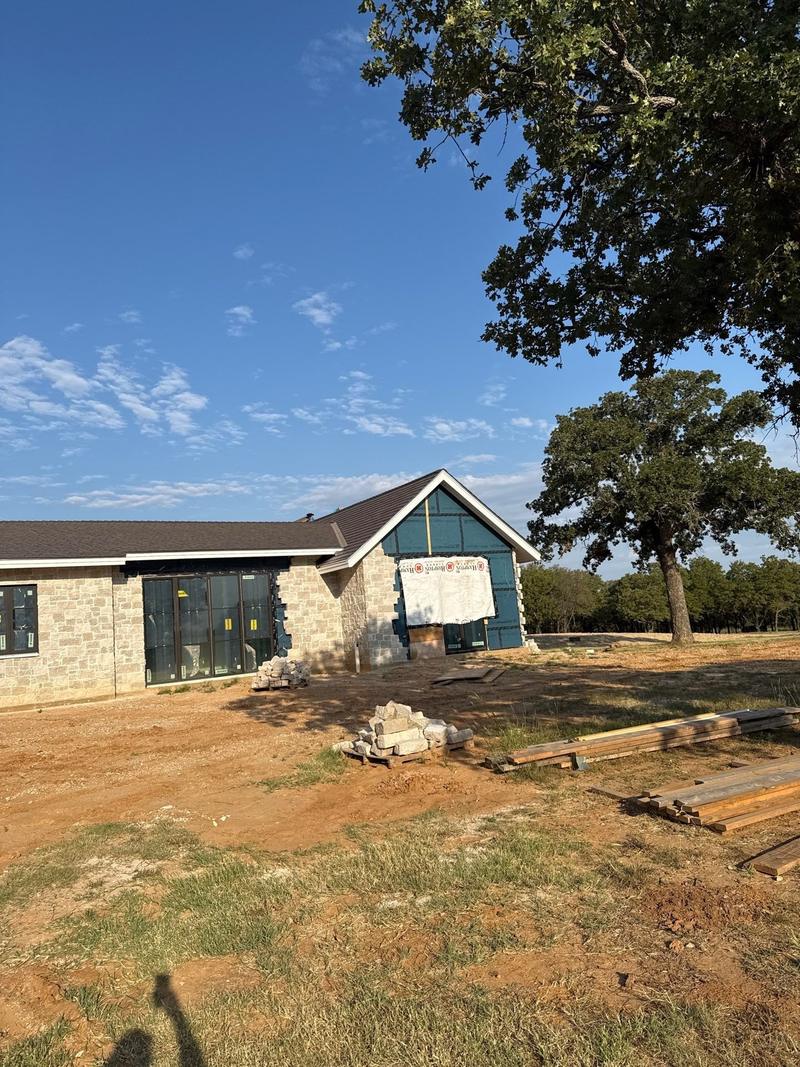 Composite cedar shake roof on a new Clay County ranch home with a glass gable entry