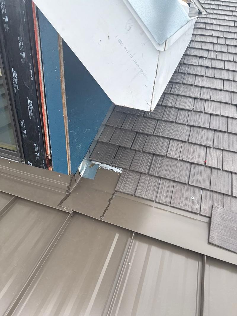 Detail of a shake-to-standing-seam metal transition