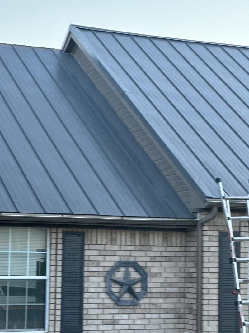 Charcoal standing seam metal roof on a brick ranch home near Rhome, TX